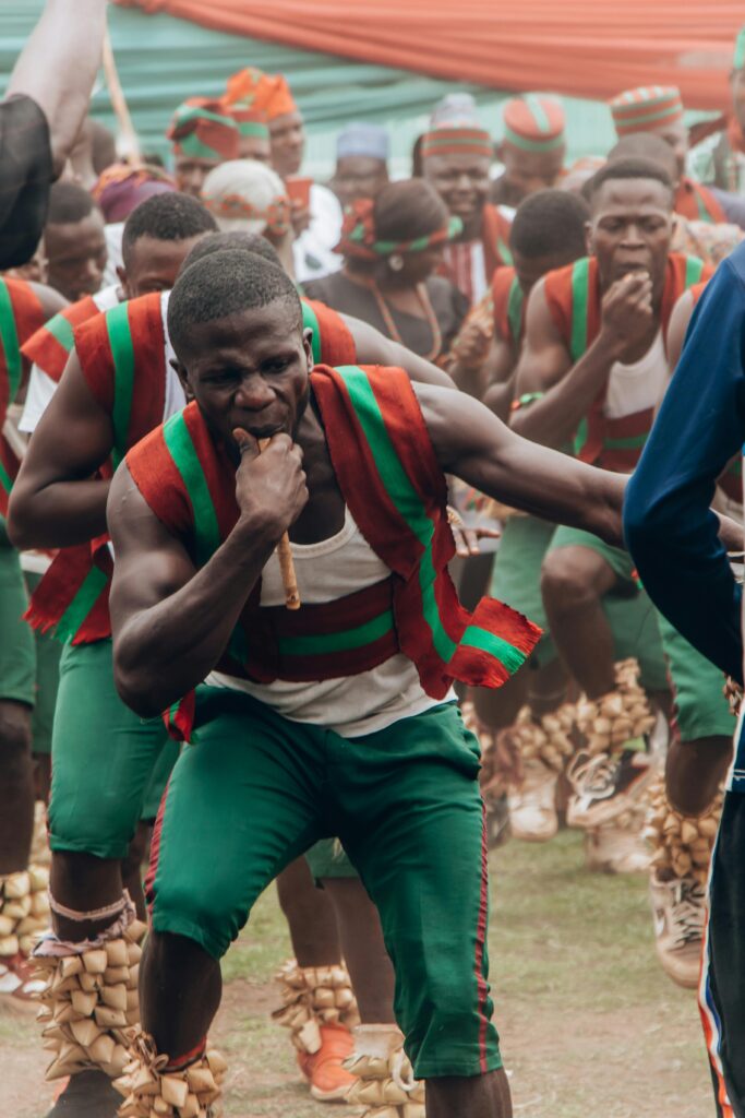 Energetic dancers in traditional attire perform at a Nigerian festival in Jos, Nigeria.
