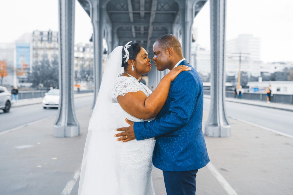 pexels-photo-14355874-14355874 Elegant wedding couple embracing on a Paris bridge, symbolizing love and togetherness.