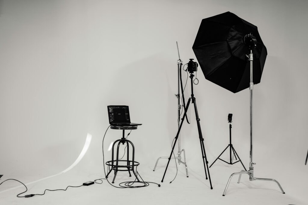 pexels-photo-2388569-2388569 A black and white photo of a well-equipped photography studio with lighting equipment and tripods.